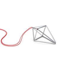 Two different size silver pendants on silk cord. The pendant prisma describes an unequal-sided double tetrahedron, reminiscent of crystal. It is made of anodized aluminum tubes invisibly strung on nylon forming the side edges of the polyhedron. The color of the silk ribbon is red.