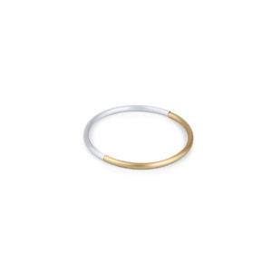 Bangle made of two-piece circle of anodized aluminum tube. One segment gold-colored, the other silver. They are connected with a rubber cord and by means of an invisible magnetic clasp the bangle can be closed.