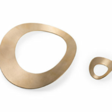 Armreif und Ring courbe aus Silber, Gold plattiert Ein Armreif und ein Ring aus Silber, Gold plattiert. Sie beschreiben jeweils einen Kreis, der Durchbruch für Finger und Arm einen weiteren, welcher außermittig gesetzt ist. Sowohl Armreif als auch Ring sind zur Achse leicht gewölbt gerundet