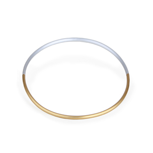 One tube is bent into a circle and then cut in half. One side gold colored the other silver anodized and connected with a strong rubber. By means of a hidden magnetic clasp, the choker can be opened and closed.