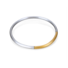 Thick choker made of bent aluminum tube. One quarter is set off in gold and connected to the three-quarter segment by a strong rubber cord. With the help of an invisible integrated magnetic clasp, the hoop can be opened.