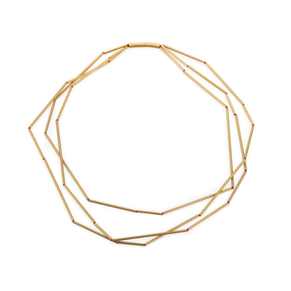 Three-row chain made of differently long and gold-colored aluminum tubes. The tubes are knotted on red pearl silk. The knots appear like red pearls in the gaps. The chain is closed by a cylindrical magnetic clasp.