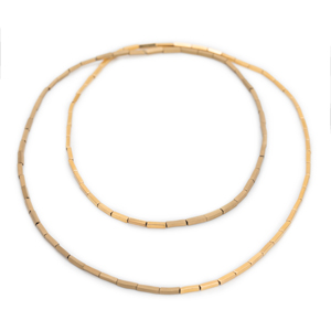 A long chain is placed twice in two circles. It is made of gold-colored small cubes and half shiny and half polished.