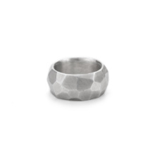 Very wide and thick ring made of sterling silver. The surface has numerous uneven facets that create an interesting appearance of light and shadow.