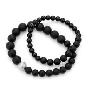 Bracelets made of different sized onyx beads strung on sturdy silicone cord. One bracelet has a silver ball strung on it.