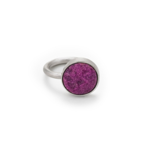 A simple silver ring with a 16mm pink cobalt calcite disc. It is not centered but slightly offset on the ring.